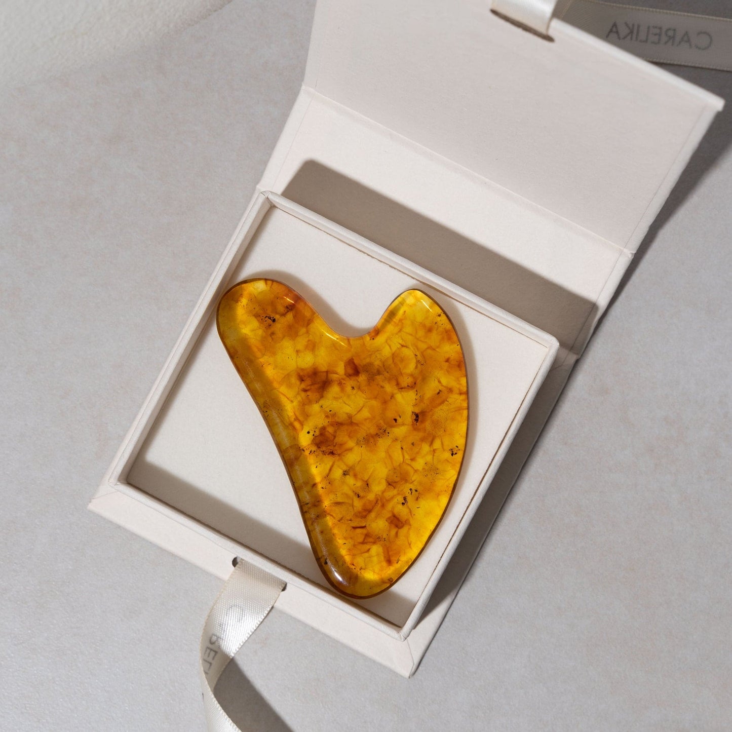 CARELIKA Amber Gua Sha Sculpting Stone in a box